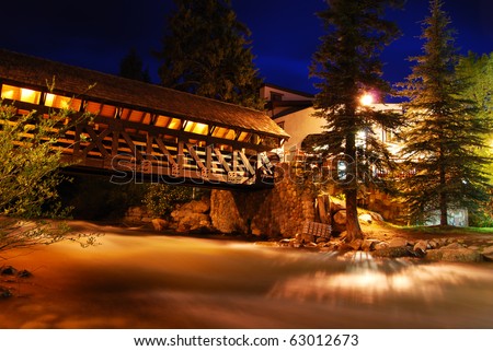 This covered bridge is lit up at night in Vail, Colorado, a popular summer and winter vacation destination for mountain bikers, skiers, and snowboarders.