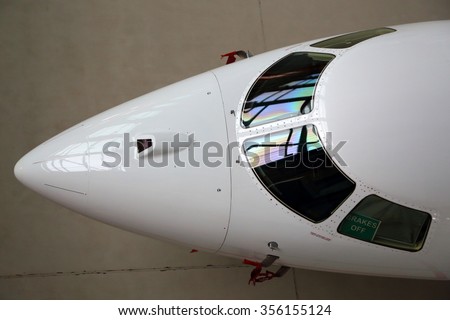 Business jet airplane cockpit glass and nose fairing.