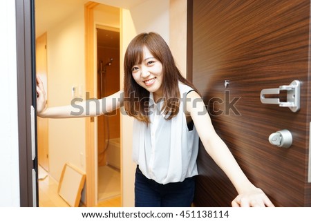 Young Japanese girl inviting her friend to her single living room with light design