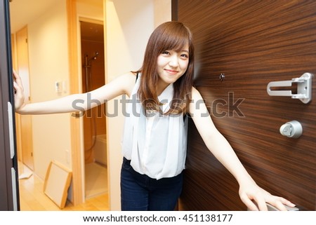 Young Japanese girl inviting her friend to her single living room with light design