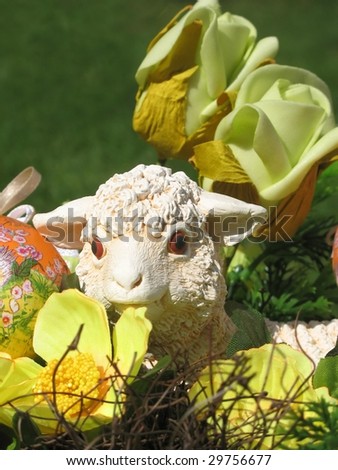Easter lamb with easter-eggs in the decoratiwe basket