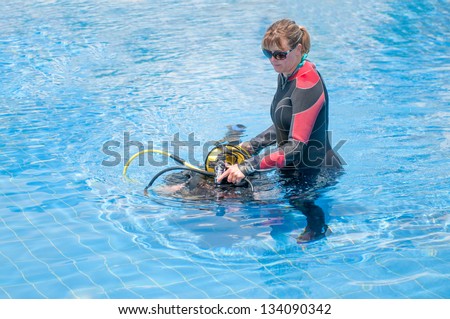 Beautiful young female learning to scuba dive