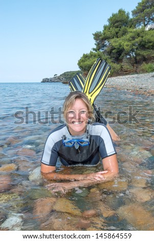 Beautiful young lady smiling and relaxing in the sea
