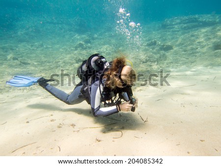 Lone female scuba diver on a dive