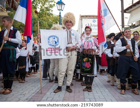 PEFKOHORI , GREECE - SEPTEMBER 19 2014 : Folk Dancers from several countries  taking part in the Annual Folk Dance festival in the village square of Pefkohori ,Greece