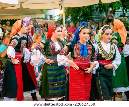 PEFKOHORI , GREECE - SEPTEMBER 19 2014 : Folk Dancers from Serbia taking part in the Annual Folk Dance festival in the village square of Pefkohori ,Greece