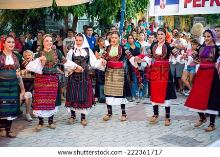 PEFKOHORI , GREECE - SEPTEMBER 19 2014 : Folk Dancers from several countries  taking part in the Annual Folk Dance festival in the village square of Pefkohori ,Greece