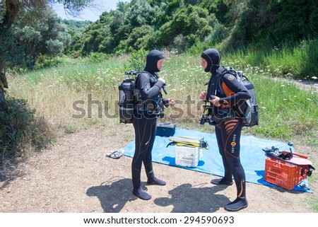 AVLAKI,GREECE-JULY 04 2015 :Two female Scuba Divers have a safety brief before they go for a dive.Diving is an adventurous sport with dive sites in most countries around the world.