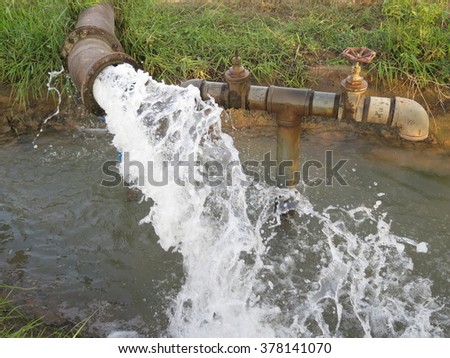 powerful water flowing from a large pipe pump using electricity machine modified convert to be water pump supply for agricultural universal use in fish , shrimp farm and paddy in country Thailand