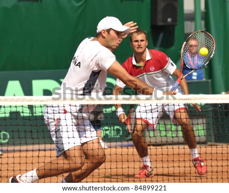 BUCHAREST - SEPT. 17: Horia Tecau and Marius Copil in action during the Davis Cup doubles match between Romania and Czech Republic, September 17 2011, Bucharest, Romania