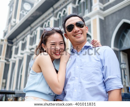 asian christian couple take a pre wedding at  cathedral outdoor