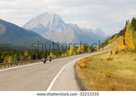 Autumn scenic view of rocky mountains, forests and road (highway 40) while traveling in kananaskis country, Alberta, Canada