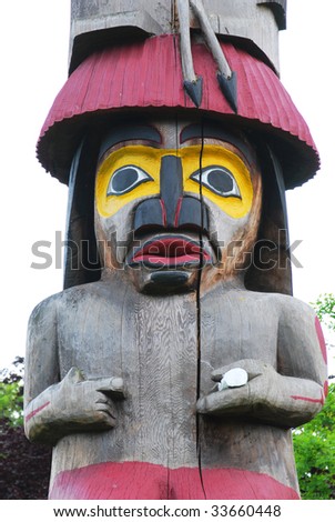 Lively carving face on a totem pole by ancient native indian american, Victoria, British Columbia, Canada
