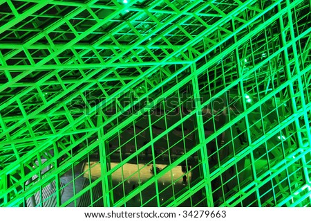 The interior look of the glass frame structure inside city hall under green lighting, edmonton, alberta, canada