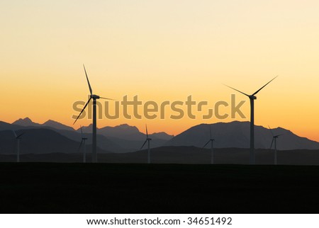 A row of windmills at dusk in pincher creek, alberta, canada. These wind turbines make pincher creek the wind energy capital of canada.