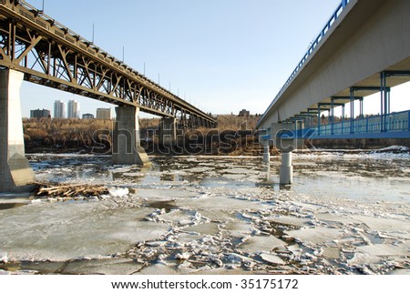 Early winter view of the north saskatchewan river with floating ice in city edmonton, alberta, canada