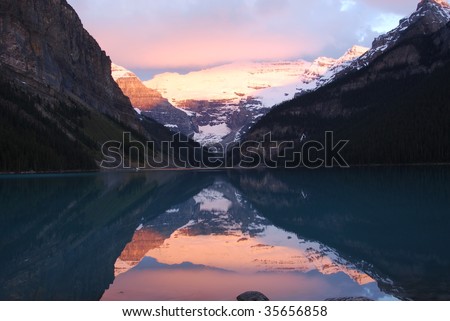 Lake louise and rosy snow mountains at sunrise moment, banff national park, alberta, canada