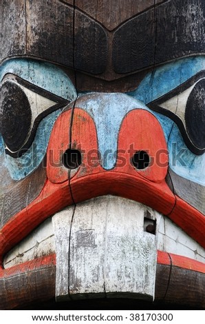 A lively wooden carving face on a totem pole by ancient native indian american, Victoria, British Columbia, Canada