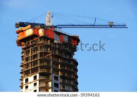 An unfinished apartment building under the blue sky from a construction site in downtown edmonton, alberta, Canada