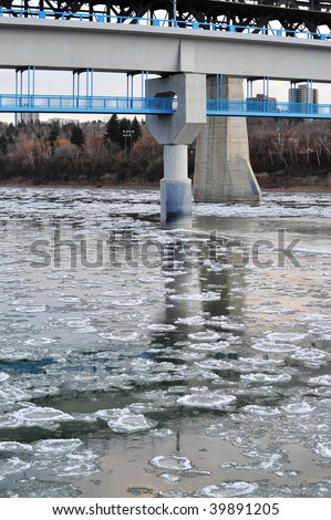 Early winter view of the north saskatchewan river with floating ice in city edmonton, alberta, canada