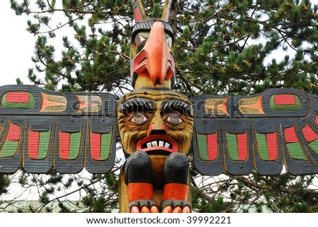 Lively carving faces on a totem pole by ancient native indian american, Victoria, British Columbia, Canada