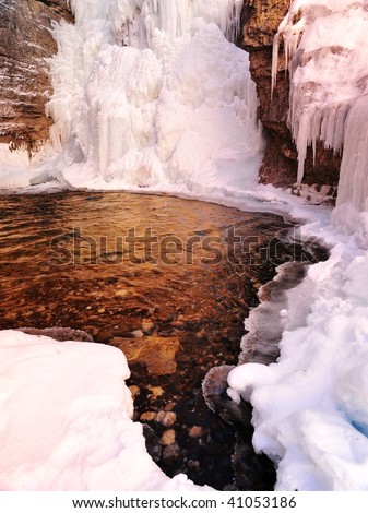 Winter creek and frozen waterfall and pond at Johnston canyon, alberta, canada