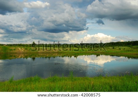 Pond reflection of sky and clouds, a public park in edmonton, alberta