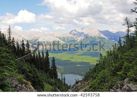 Summer view of rocky mountains and lake in lights and shadows, kananaskis country, alberta, canada