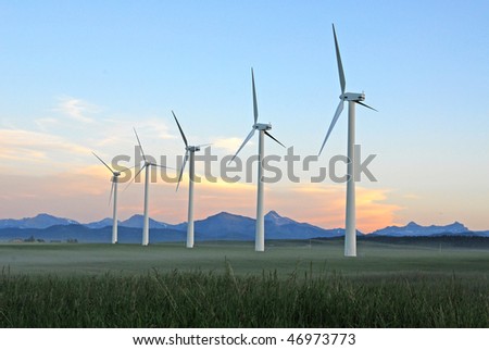A row of windmills at dusk in pincher creek, alberta, canada. These wind turbines make pincher creek the wind energy capital of canada