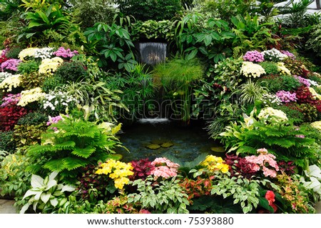 Flowers and waterfall in indoor garden, vancouver island, british columbia, canada