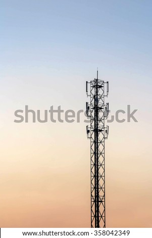 Telecommunication cellular tower on twilight background. Used to transmit television and telephone signal
