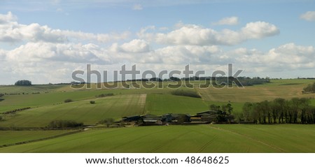 Big cloudy blue sky above an springs fields  in Wiltshire, England.
