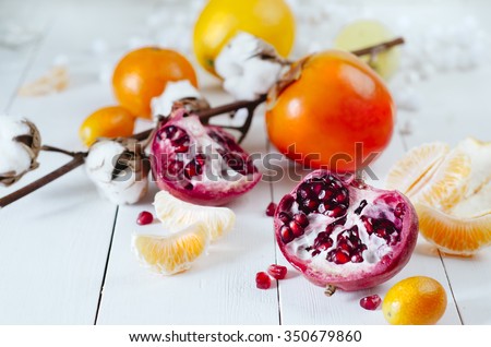 Winter fruits - pomegranates, tangerines, oranges, persimmons, kumquats