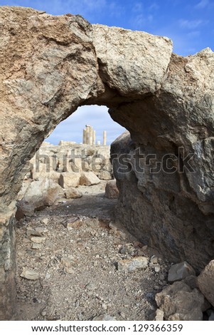 Ruins of King Herod\'s palace or castle on top of the mountain seen through an old arch in Mukawir (Mkawer) Jordan, Arabia, Middle East.