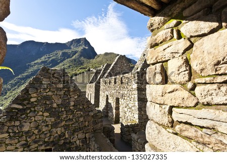 Ruin of Inca houses in Machu Picchu - the lost Inca city high in the Andes mountains in South America