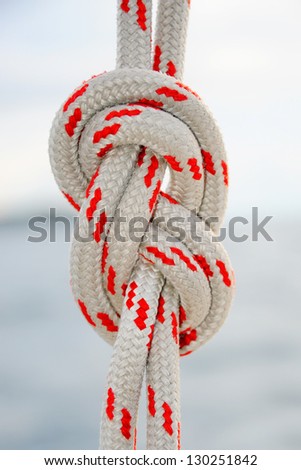 Sailing rope tied in a knot at sea background