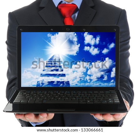 Businessman holding an open laptop. Isolated on white background