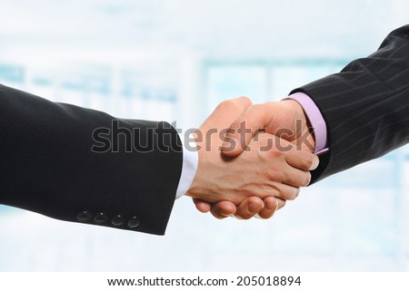 Businessman holds out his hand for a handshake. Isolated on white background