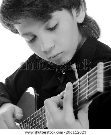 Little boy musician playing on acoustic guitar. Isolated on a white background