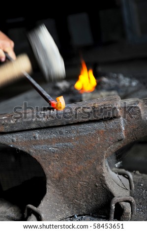 blacksmith forges iron in the forge