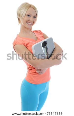 young athletic woman with an apple and scales  in the hands of. Isolated on white background