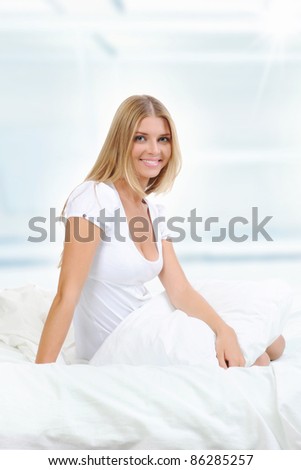 image of a young beautiful woman on the bed.
