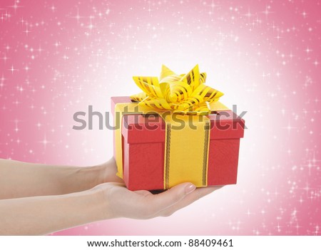 Box with a gift in the hands of women.