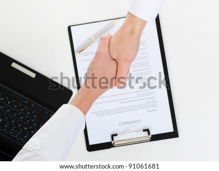 Women handshake of business partners, when signing contract.