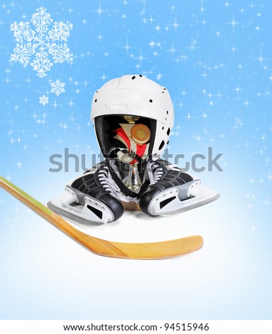 Hockey stick ice skating helmet cup winner. on blue background