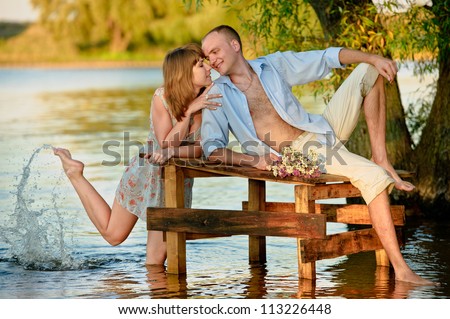 adorable young woman and handsome man on the river side