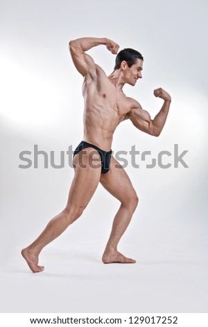 Attractive male body builder, demonstrating contest pose