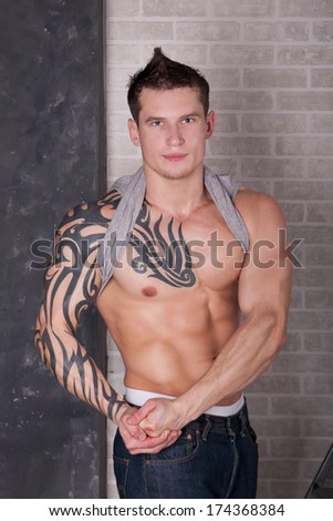 Studio shot of Muscular Sexy Man with tattoo