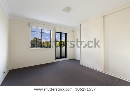 Empty house interior. Spacious family room with clean carpet floor