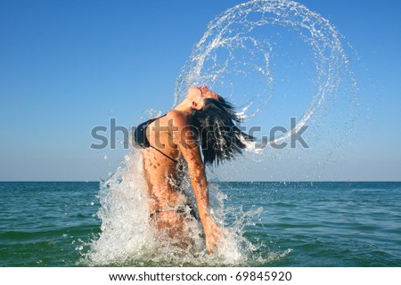 Brunette in the water waving hair
